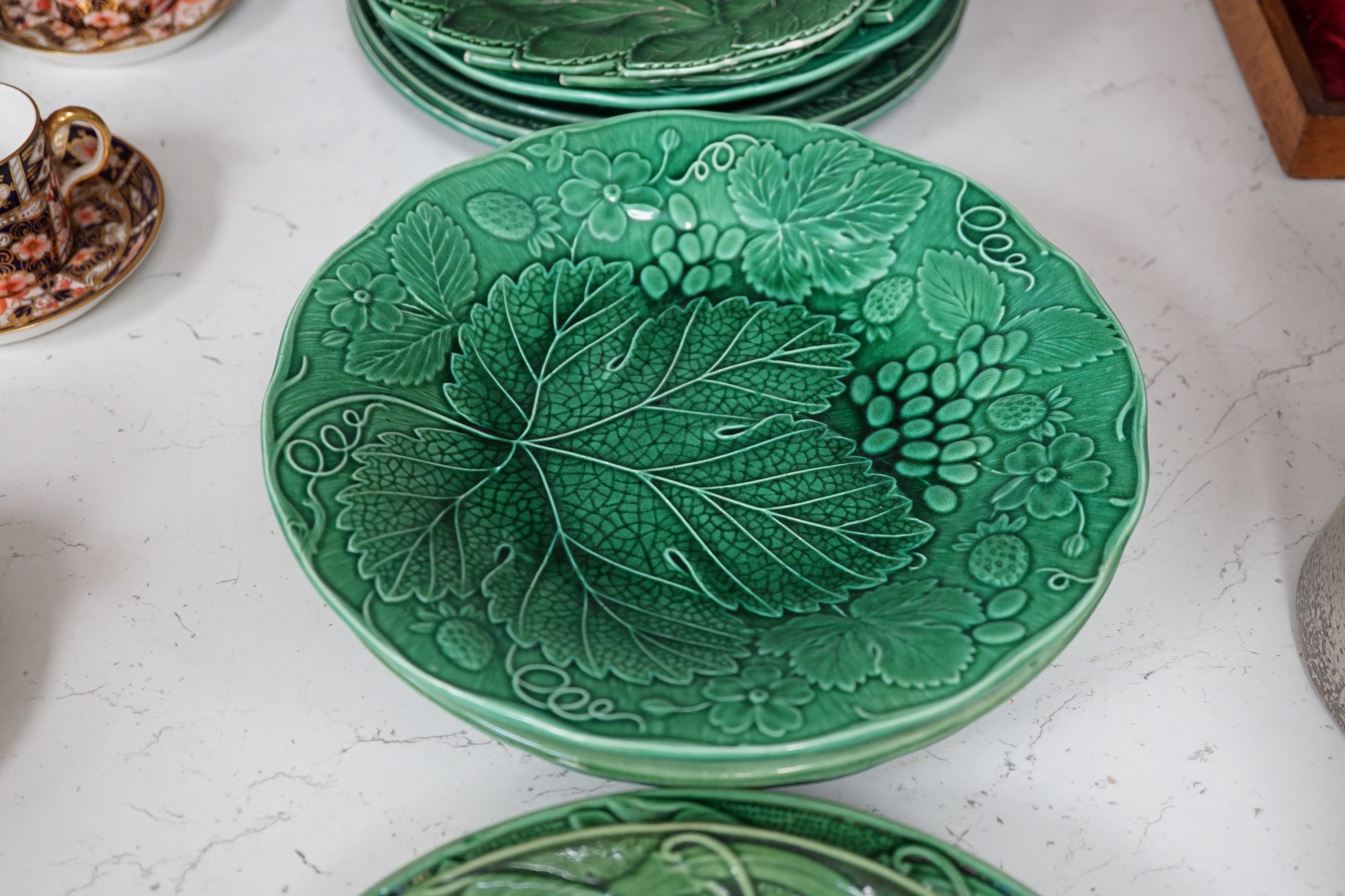 A collection of Victorian greenware leaf plates and dishes